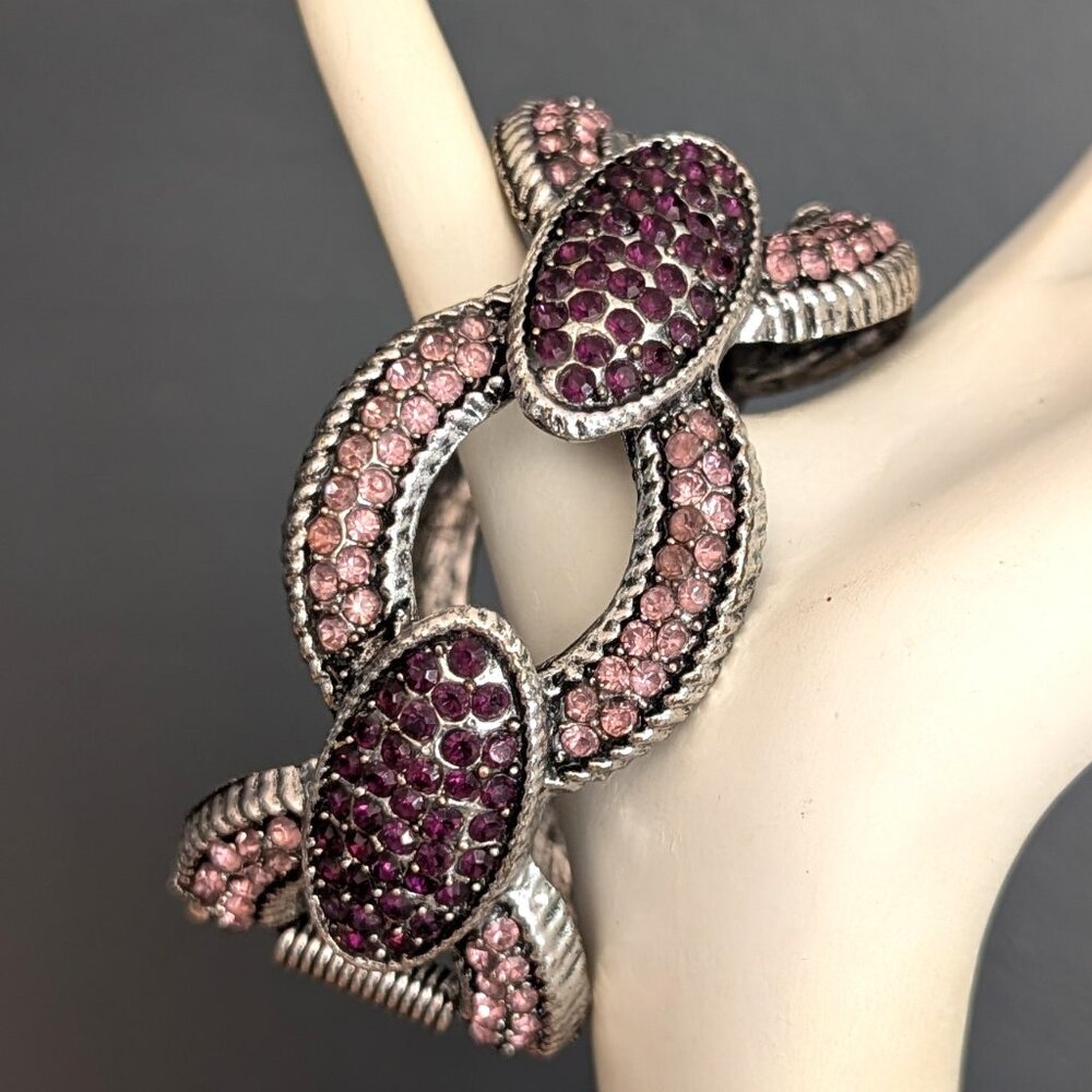 Silver tone clamper bracelet with pink and purple crystals